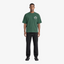 Male model wearing STF forest green flame T-shirt front