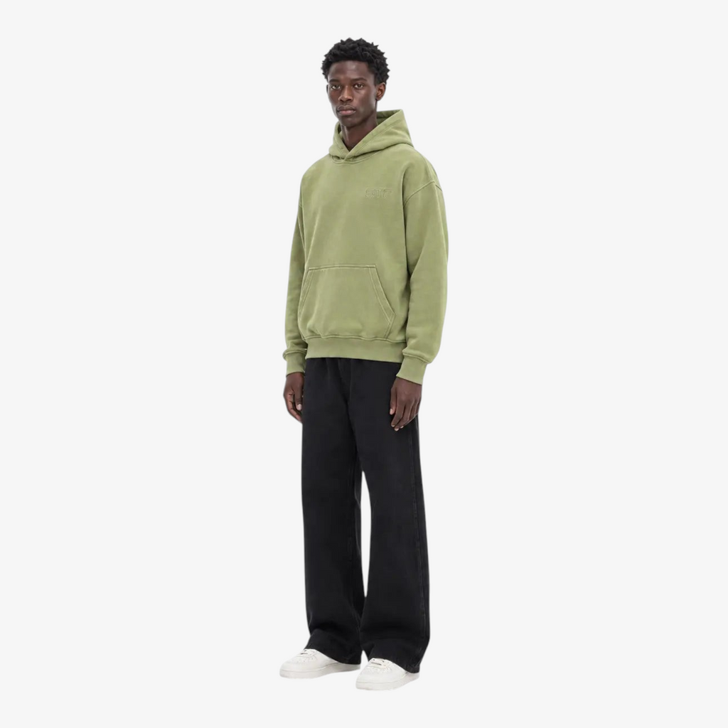 Model wearing STF oversized olive hoodie three-quarter view