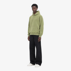 Model wearing STF oversized olive hoodie three-quarter view
