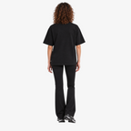 Female model wearing STF black boxy oversized T-shirt back view