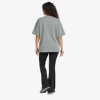 Female model wearing STF sage-grey boxy oversized T-shirt back view