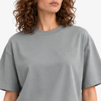 Female model wearing STF sage-grey T-shirt embroidery close-up