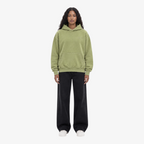 Female model wearing STF oversized olive unisex hoodie front view