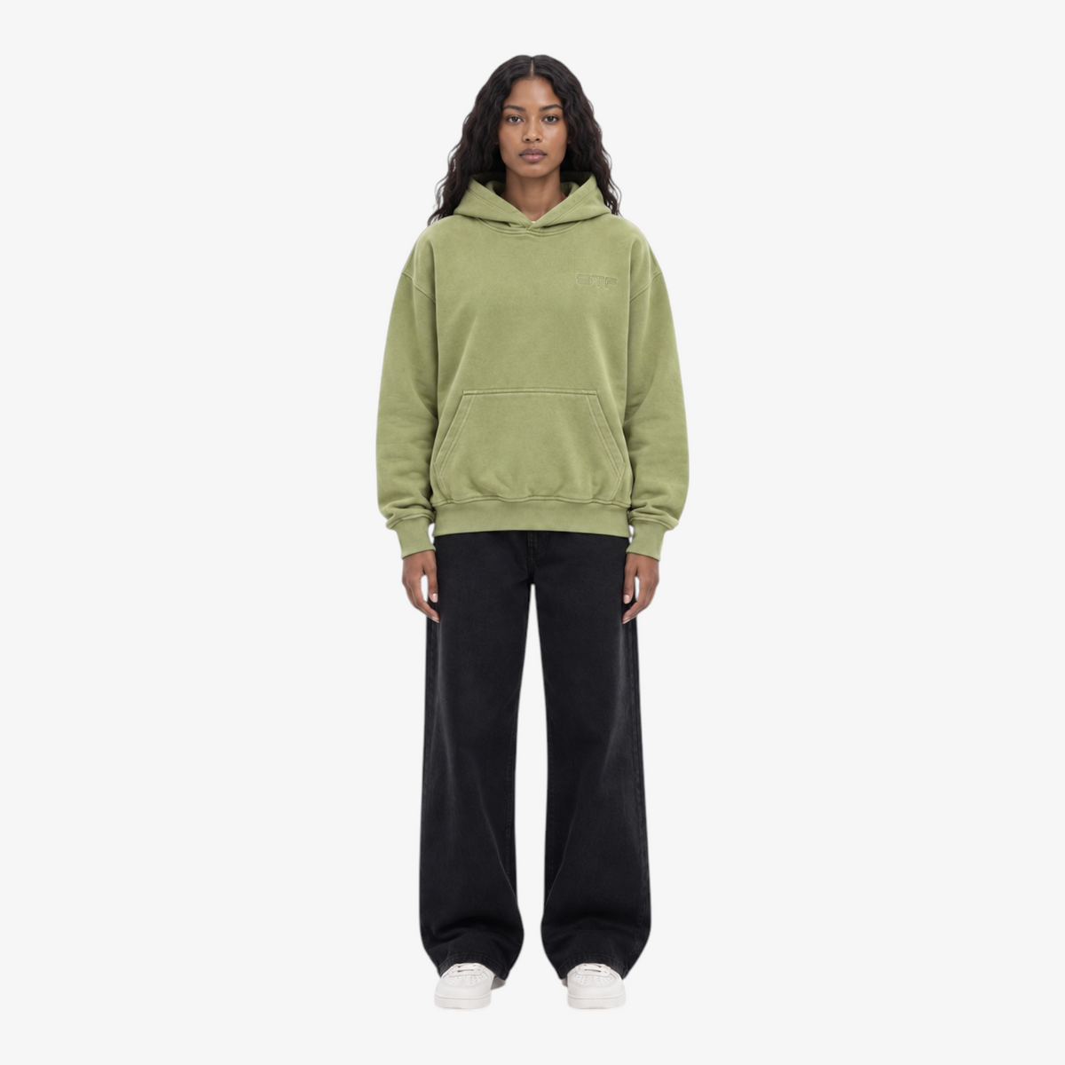 Female model wearing STF oversized olive unisex hoodie front view