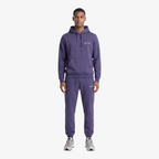 Model wearing a Seejthreadsflames (STF) purple heavyweight cotton tracksuit with an oversized hoodie and joggers.