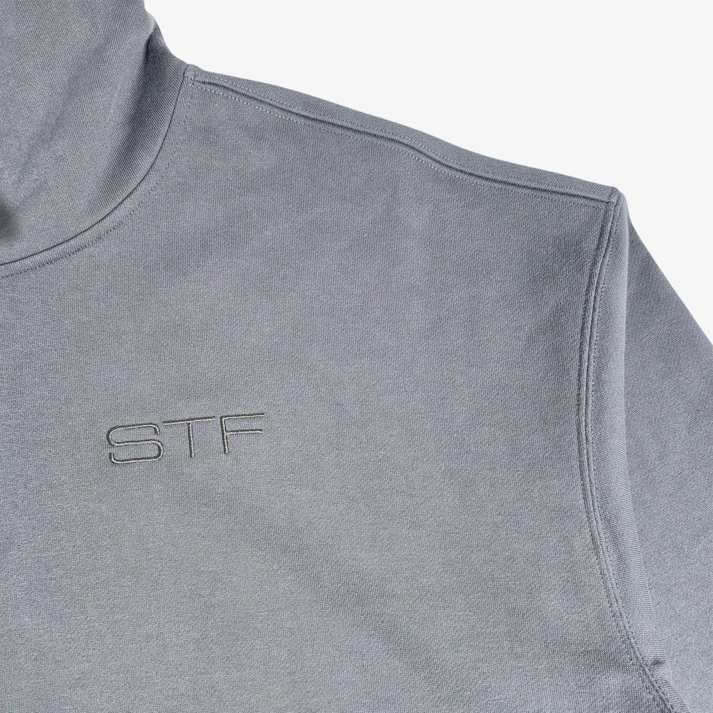 Close-up of Seejthreadsflames (STF) charcoal grey heavyweight French terry hoodie with tonal chest embroidery.