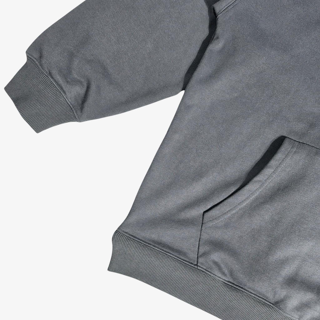 Close-up of Seejthreadsflames (STF) charcoal grey heavyweight French terry hoodie with ribbed hem and kangaroo pocket.