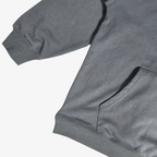Close-up of Seejthreadsflames (STF) charcoal grey heavyweight French terry hoodie with ribbed hem and kangaroo pocket.