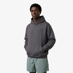 Model wearing a Seejthreadsflames (STF) charcoal grey heavyweight oversized French terry hoodie with chest embroidery.