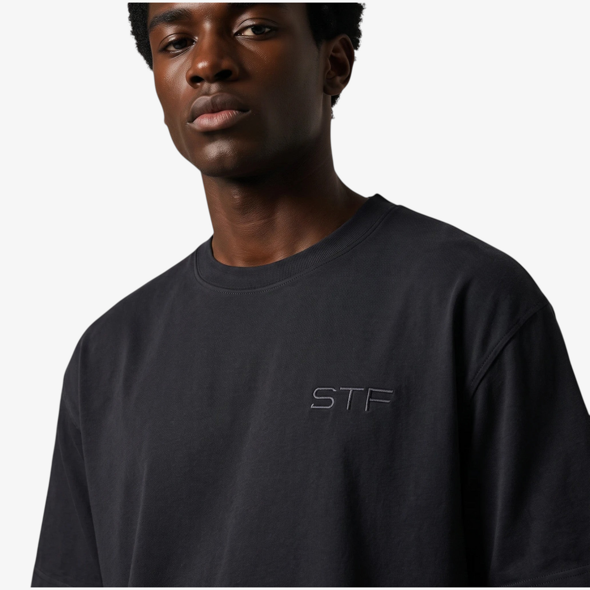 Model wearing the black STF tonal embroidered T-shirt