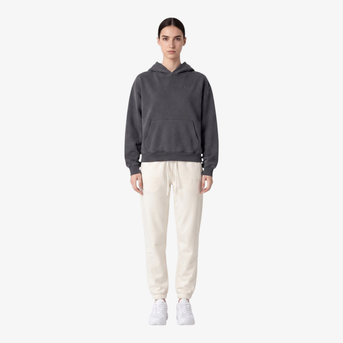 Model wearing Seejthreadsflames (STF) cream heavyweight joggers with elasticated cuffs and tonal embroidery