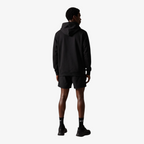 Back view of a man wearing a Seejthreadsflames (STF) black heavyweight cotton oversized hoodie and matching shorts.