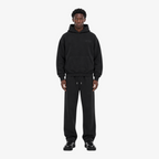Male model wearing the STF black heavyweight tracksuit, front view