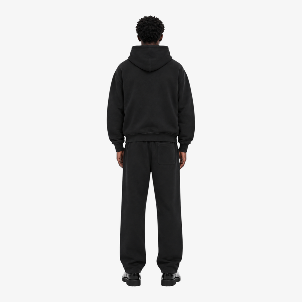 Male model wearing the STF black heavyweight tracksuit, back view