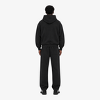 Male model wearing the STF black heavyweight tracksuit, back view