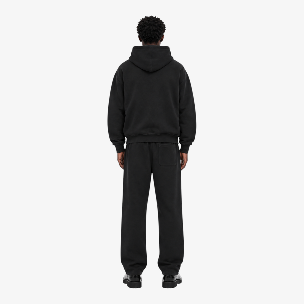 Male model wearing the STF black heavyweight tracksuit, back view