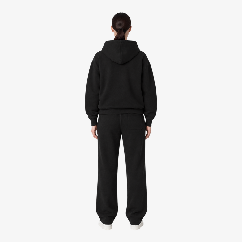 Female model wearing the STF black heavyweight tracksuit, back view