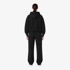 Female model wearing the STF black heavyweight tracksuit, back view